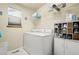 Functional laundry room with washer, dryer, storage shelves and a shoe rack at 5211 E 116Th Ave, Thornton, CO 80233