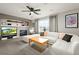 Cozy living room with a fireplace, custom shelving, and a comfortable white sectional at 5211 E 116Th Ave, Thornton, CO 80233