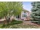 Charming backyard showcasing a well-maintained lawn, mature trees, and a cozy patio at 1844 S Jay Way, Lakewood, CO 80232
