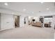 Spacious finished basement with plush carpet, recessed lighting, and ample seating at 1844 S Jay Way, Lakewood, CO 80232