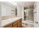 Bright bathroom featuring tile floor, shower, and vanity with neutral color palette at 1844 S Jay Way, Lakewood, CO 80232