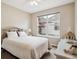 Bedroom features white decor, a plush carpet, and a large window providing plenty of natural light at 1844 S Jay Way, Lakewood, CO 80232