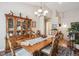 Spacious dining room boasting a large china cabinet, decorative chandelier, and views into the main living area at 1844 S Jay Way, Lakewood, CO 80232