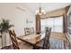 Elegant dining room featuring a large window, chandelier lighting, and a beautifully set table for gatherings at 1844 S Jay Way, Lakewood, CO 80232