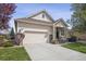 Charming home featuring a two-car garage, well-manicured lawn, and inviting front porch at 1844 S Jay Way, Lakewood, CO 80232