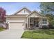 Charming single-Gathering home featuring a well-manicured lawn, two-car garage, and inviting covered front porch at 1844 S Jay Way, Lakewood, CO 80232