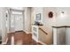 Welcoming foyer features gleaming hardwood floors, a decorative shelf, and abundant natural light at 1844 S Jay Way, Lakewood, CO 80232