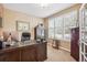 Bright home office featuring a large window with plantation shutters, a spacious desk, and ample storage at 1844 S Jay Way, Lakewood, CO 80232