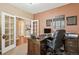Well-appointed home office with a rich wood desk, French doors, and access to the home's entryway at 1844 S Jay Way, Lakewood, CO 80232