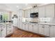 Bright kitchen with white cabinets, granite countertops, and stainless steel appliances, offering modern convenience at 1844 S Jay Way, Lakewood, CO 80232