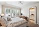 Bright main bedroom features plantation shutters, tray ceiling and ensuite bath access at 1844 S Jay Way, Lakewood, CO 80232