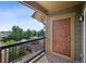 View of the neighborhood from the balcony; features a solid wood door, and iron railing at 8778 S Kipling Way # 304, Littleton, CO 80127