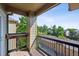 A covered balcony overlooking a quiet neighborhood with garages at 8778 S Kipling Way # 304, Littleton, CO 80127