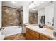 Cozy bathroom with updated tile, shower and tub, vanity, and a large mirror at 8778 S Kipling Way # 304, Littleton, CO 80127