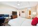 Spacious bedroom with decorative lighting, a media center, a closet, and access to the bathroom at 8778 S Kipling Way # 304, Littleton, CO 80127