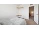 Bedroom with carpeted floors, a bed and closet with built-in shelves, and adjacent access to the stairs at 8778 S Kipling Way # 304, Littleton, CO 80127