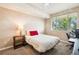 Comfortable bedroom with lots of light, a ceiling fan, and an adjacent desk for a home office at 8778 S Kipling Way # 304, Littleton, CO 80127