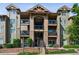 Attractive multi-story condo building with stone accents, private balconies and manicured landscaping at 8778 S Kipling Way # 304, Littleton, CO 80127