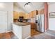 Well-lit kitchen featuring granite countertops, stainless steel appliances, and wood flooring at 8778 S Kipling Way # 304, Littleton, CO 80127