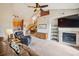 Spacious living room with vaulted ceiling, fireplace, and open layout to kitchen and dining area at 8778 S Kipling Way # 304, Littleton, CO 80127