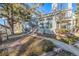 Exterior view of a well-maintained townhome with a staircase and landscaped front yard at 4084 S Carson St # A, Aurora, CO 80014