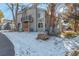 Townhouse exterior with snowy landscaping and walkway at 4084 S Carson St # A, Aurora, CO 80014