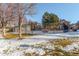 Neighborhood fenced pool area surrounded by trees in a snowy landscape on a sunny day at 4084 S Carson St # A, Aurora, CO 80014