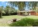 Lush backyard with mature trees providing shade and privacy for outdoor enjoyment at 8304 Eaton Way, Arvada, CO 80003