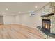 Spacious basement featuring a stone fireplace and wood laminate flooring at 8304 Eaton Way, Arvada, CO 80003
