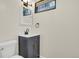 Close up of a vanity and commode in a modern bathroom with neutral accents and a window at 8304 Eaton Way, Arvada, CO 80003