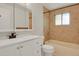 Bathroom featuring modern vanity, mirror, and bathtub with shower at 8304 Eaton Way, Arvada, CO 80003