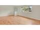 Neutral bedroom with hardwood floors, closet, and a large window overlooking the yard at 8304 Eaton Way, Arvada, CO 80003
