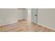 A bedroom with neutral walls, wood floors, a closet, and doorway at 8304 Eaton Way, Arvada, CO 80003