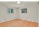 Bedroom with two windows allowing natural light and hardwood floors at 8304 Eaton Way, Arvada, CO 80003