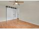 Primary bedroom featuring a large sliding closet door and wood floor at 8304 Eaton Way, Arvada, CO 80003