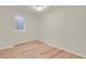 Neutral bedroom features wood-look floors and natural light from a window at 8304 Eaton Way, Arvada, CO 80003