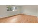 Bright bedroom with hardwood floors and a large window overlooking the neighborhood at 8304 Eaton Way, Arvada, CO 80003