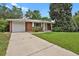 Exterior view of brick home with driveway and one car garage at 8304 Eaton Way, Arvada, CO 80003