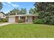 Charming brick home featuring a well-manicured front lawn and attached one car garage at 8304 Eaton Way, Arvada, CO 80003
