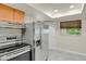 Bright kitchen featuring stainless steel appliances and tiled flooring at 8304 Eaton Way, Arvada, CO 80003