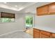 A kitchen features white countertops, wood cabinets, and sliding door to an outside deck at 8304 Eaton Way, Arvada, CO 80003