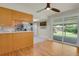 An eat-in kitchen features wood cabinetry, stainless appliances, and a sliding door to the deck at 8304 Eaton Way, Arvada, CO 80003
