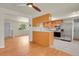 Updated kitchen boasts stainless steel appliances, white countertops and hardwood floors at 8304 Eaton Way, Arvada, CO 80003
