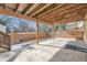 Back patio with an exposed rafter ceiling and a fenced in backyard at 9241 Roadrunner St, Highlands Ranch, CO 80129