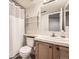 Bright bathroom with a large mirror, white tile backsplash, and open shelving at 9241 Roadrunner St, Highlands Ranch, CO 80129