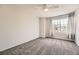 Clean and bright bedroom featuring a large window and neutral carpet at 9241 Roadrunner St, Highlands Ranch, CO 80129