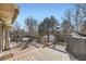 Spacious wooden deck perfect for outdoor dining, features a glass table and grill at 9241 Roadrunner St, Highlands Ranch, CO 80129