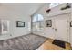 Bright open living room featuring large windows, neutral walls, and plush gray carpet at 9241 Roadrunner St, Highlands Ranch, CO 80129