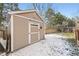 Backyard shed in a fenced in yard with mature trees and the words 'Experts Only' on the door at 9241 Roadrunner St, Highlands Ranch, CO 80129