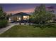 Charming home at twilight featuring a well-manicured lawn, flowering plants, and a lovely outdoor seating area at 6868 S Birch Way, Centennial, CO 80122